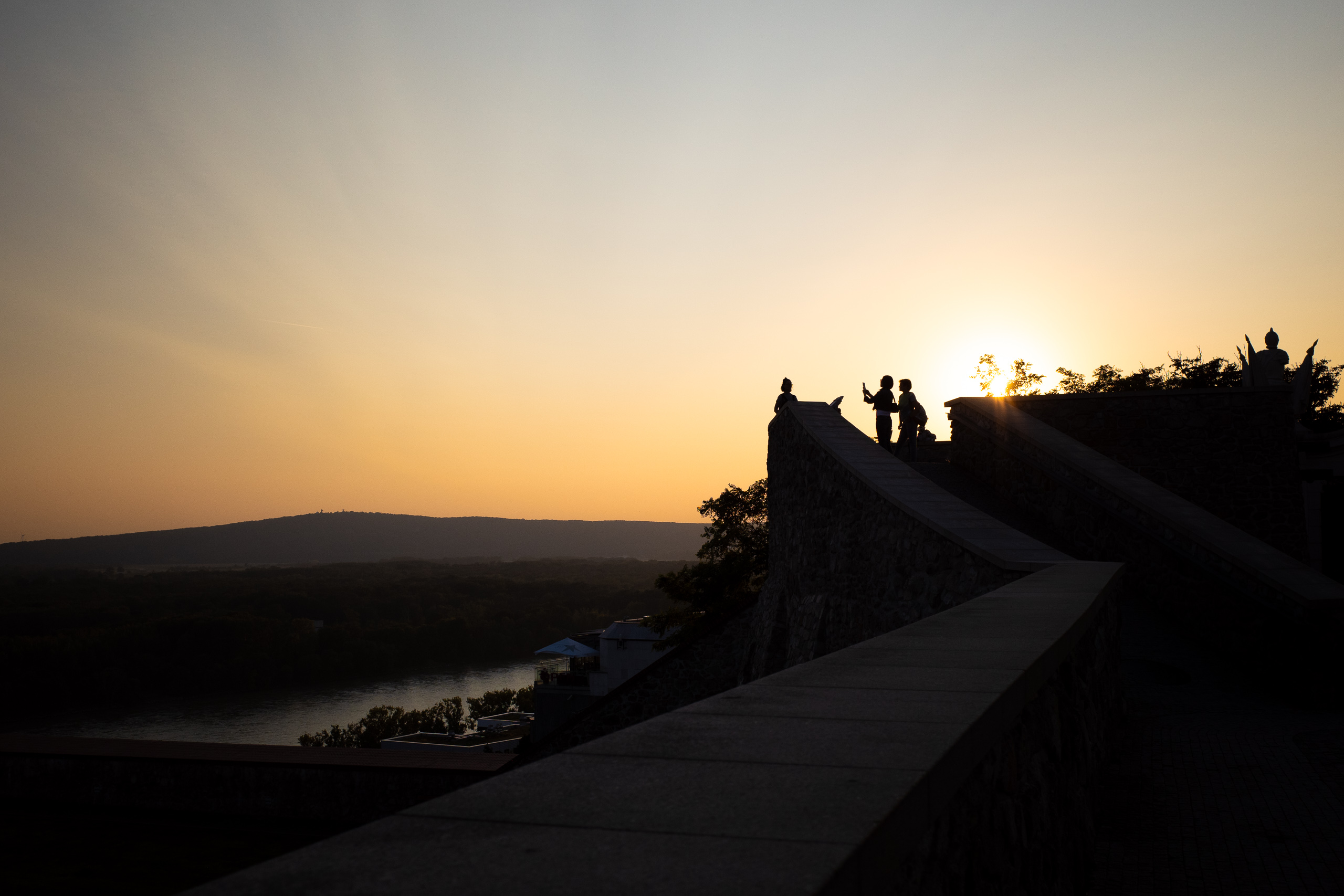 Sonnenuntergang auf der Burgmauer – zwei Silhouetten im Gegenlicht